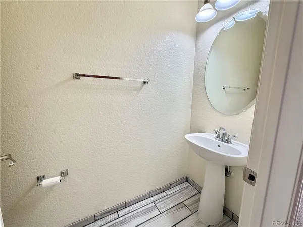 a bathroom with a sink mirror and toilet
