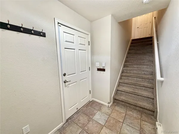 a view of a hallway with wooden floor and entryway