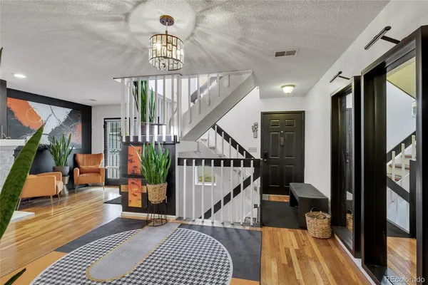 a view of entryway and hall with wooden floor