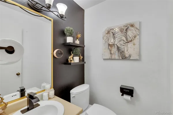 a white toilet sitting next to a bathroom sink