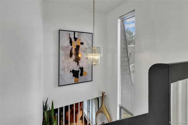 a view of a hallway with wooden floor and entryway