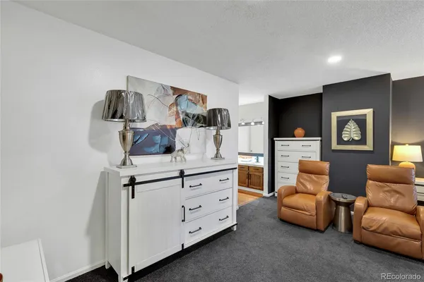 a living room with furniture and a lamp