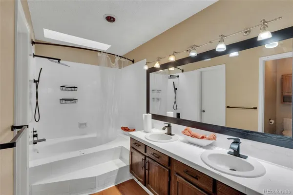 a bathroom with a double vanity sink mirror double and shower