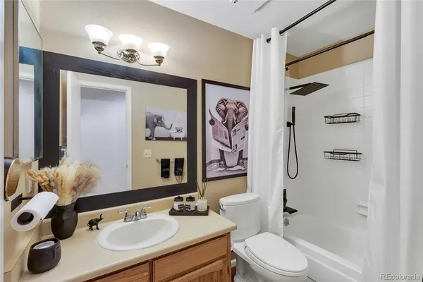 a bathroom with a sink vanity mirror and toilet