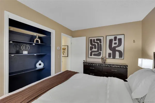 a bedroom with a bed and cabinets