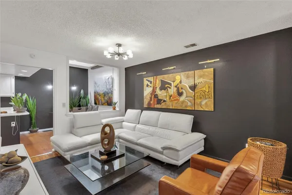 a living room with furniture and a chandelier