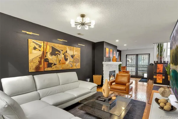 a living room with furniture fireplace and a large window