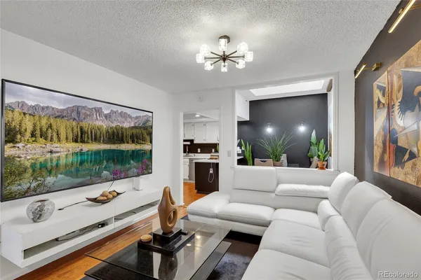 a living room with furniture fireplace and a large window