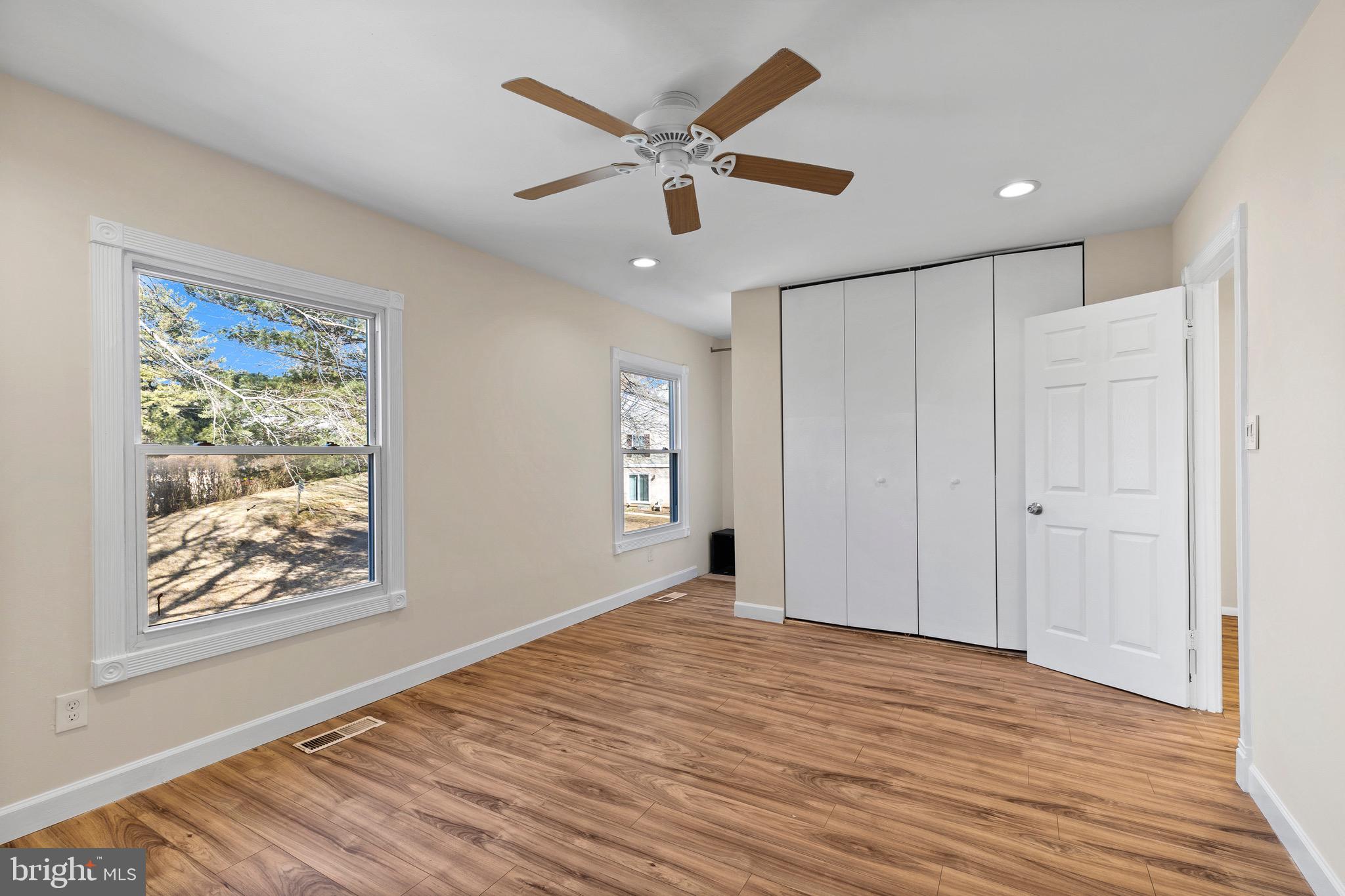 38 Deepspring Court Reisterstown, MD 21136 - Photo 12 of 17 a view of an empty room with wooden floor and a ceiling fan