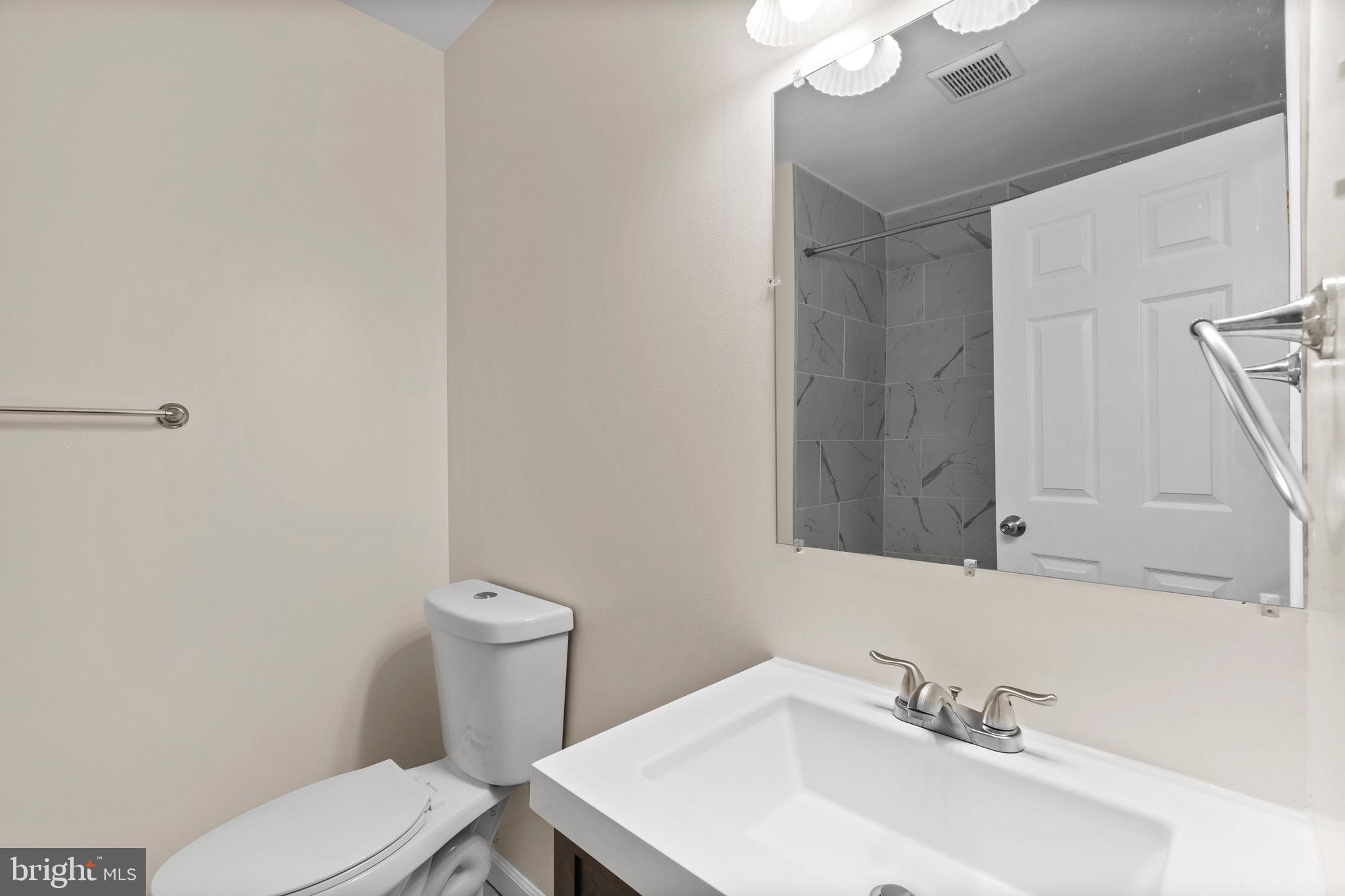 38 Deepspring Court Reisterstown, MD 21136 - Photo 17 of 17 a bathroom with a sink a toilet and mirror