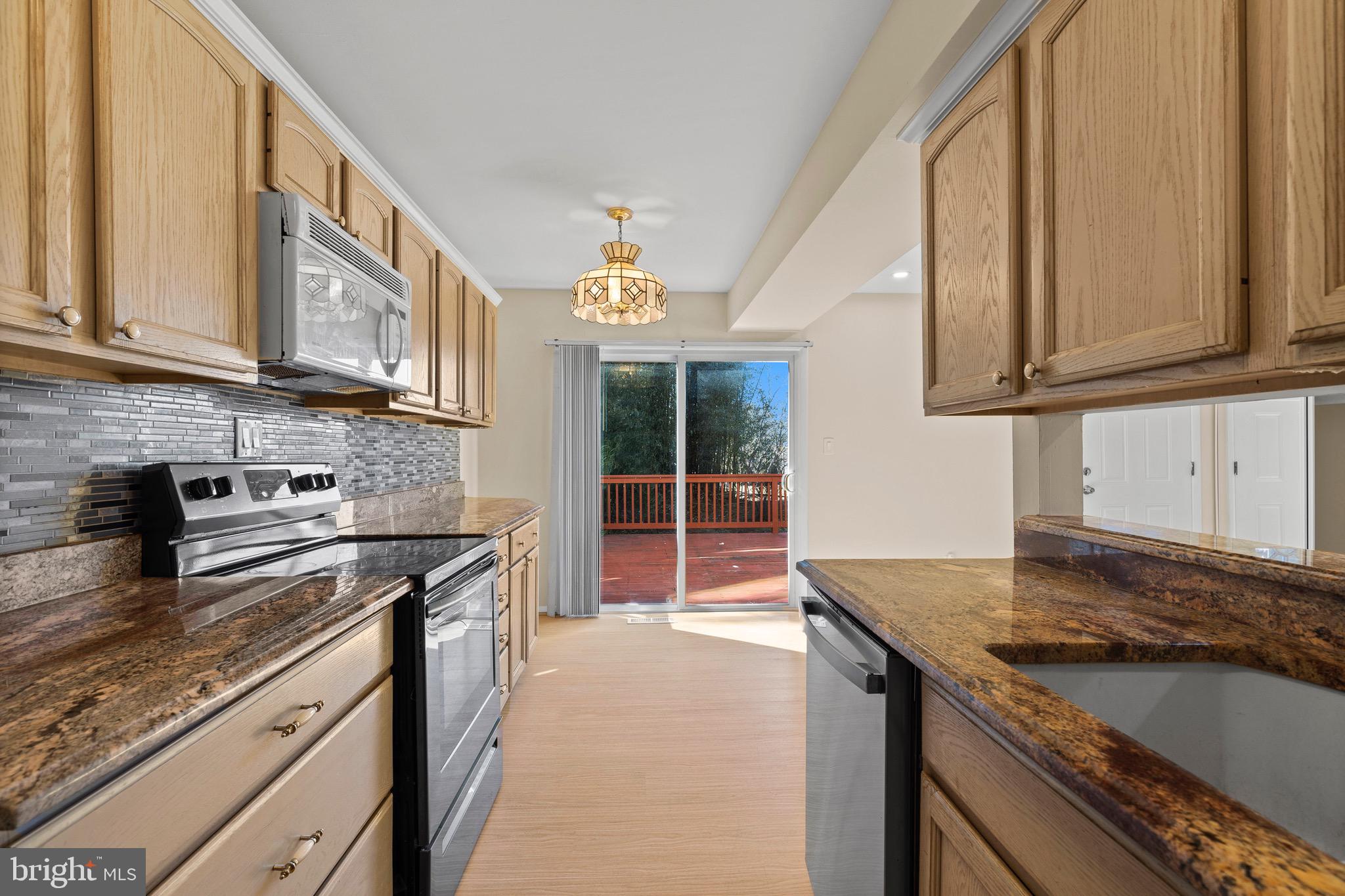 38 Deepspring Court Reisterstown, MD 21136 - Photo 6 of 17 a kitchen with stainless steel appliances granite countertop a stove a sink and a microwave