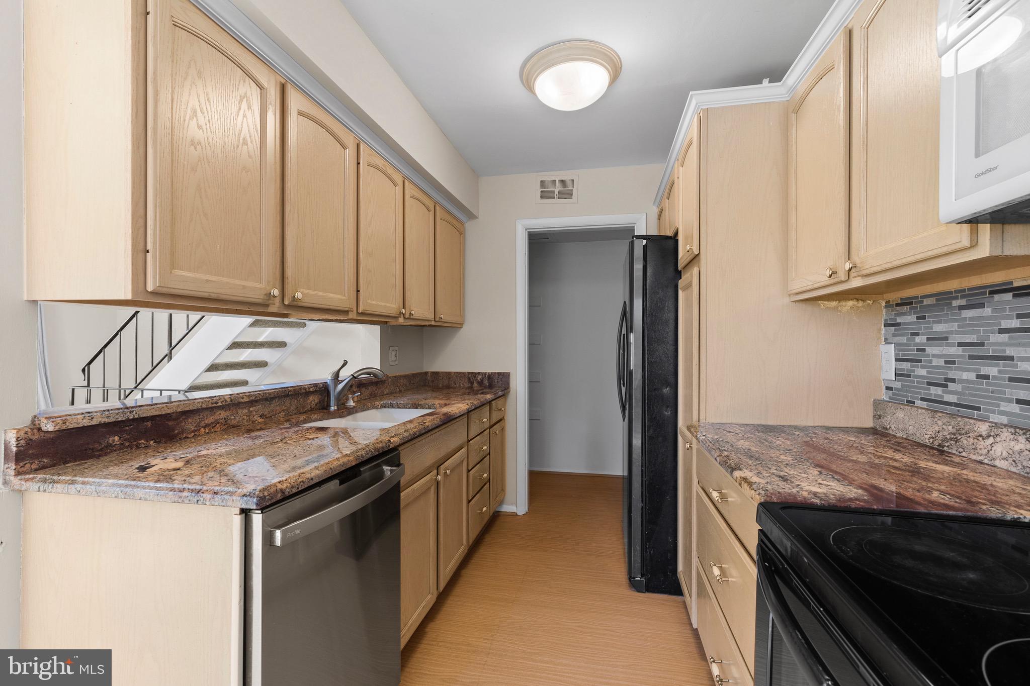 38 Deepspring Court Reisterstown, MD 21136 - Photo 7 of 17 a kitchen with granite countertop a sink stove and refrigerator