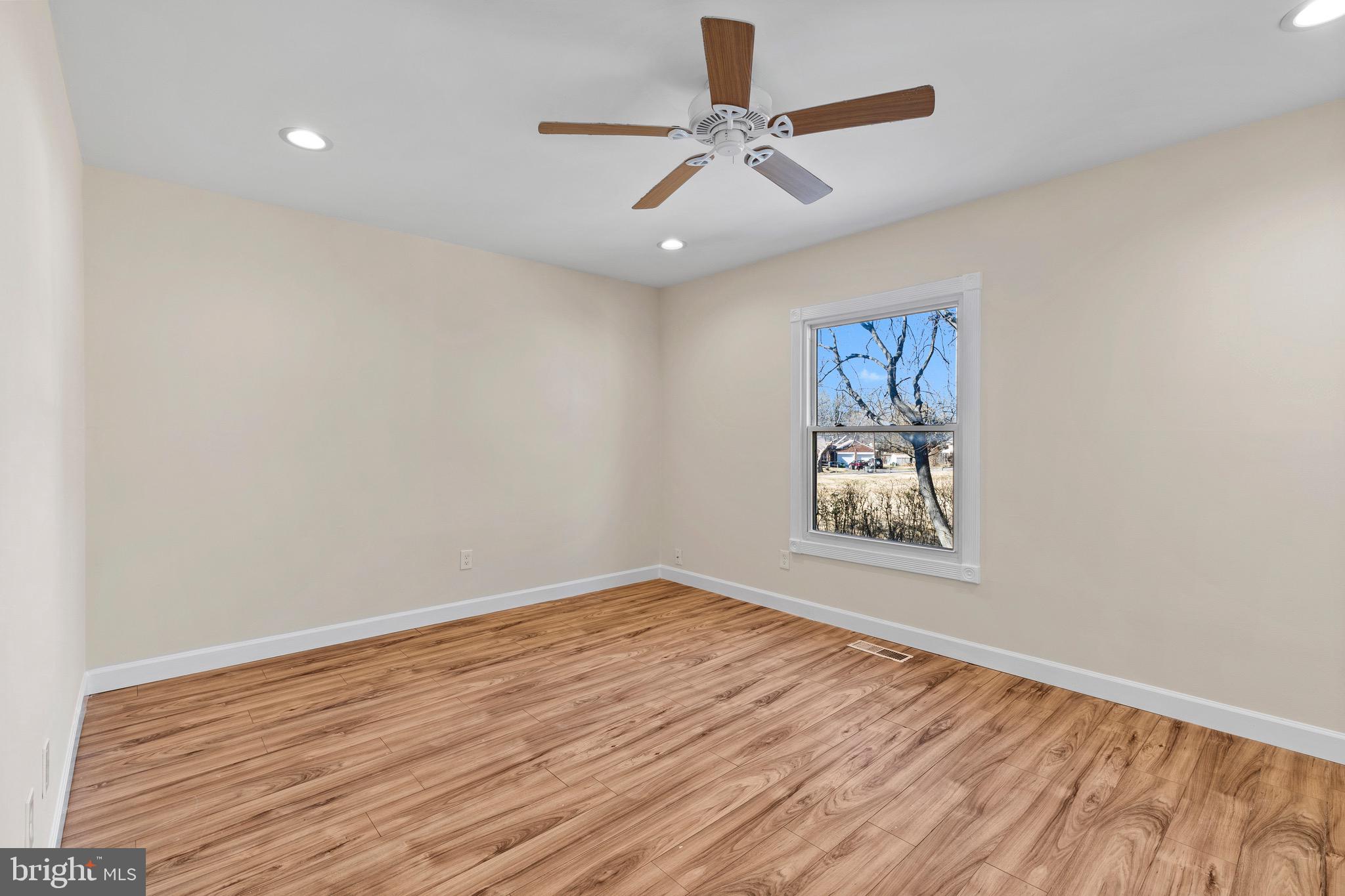 38 Deepspring Court Reisterstown, MD 21136 - Photo 9 of 17 wooden floor in an empty room with a window