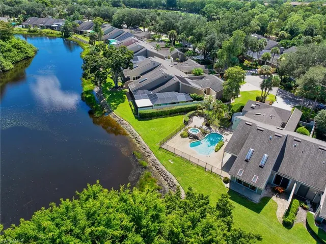 an aerial view of a house with a garden and lake view