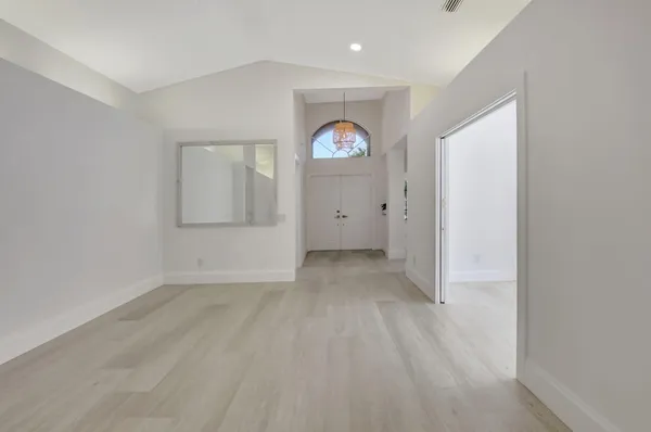 a view of a room with wooden floor and window