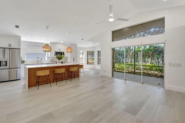 a large kitchen with a large window and stainless steel appliances