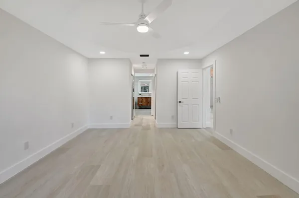 a view of swimming pool with lake and trees in the background