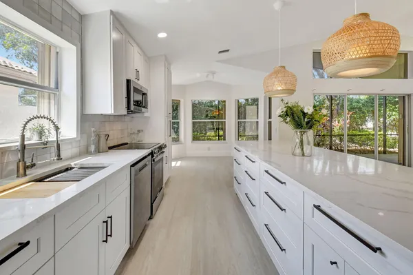 a bathroom with a tub a sink a mirror and a shower in it