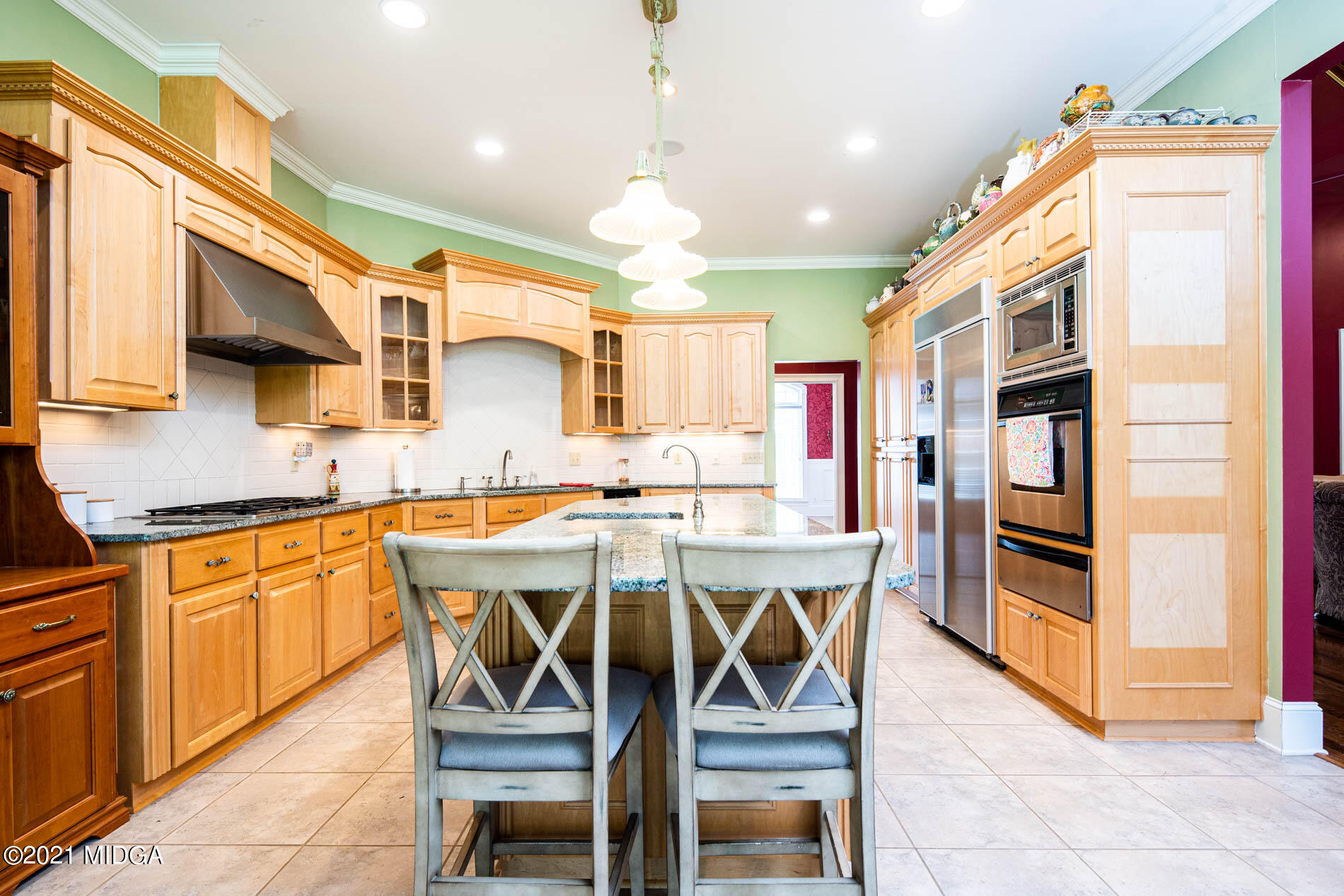 2138 Midway Road Lizella, GA 31052 - Photo 21 of 47 a kitchen with stainless steel appliances granite countertop wooden cabinets a dining table and chairs