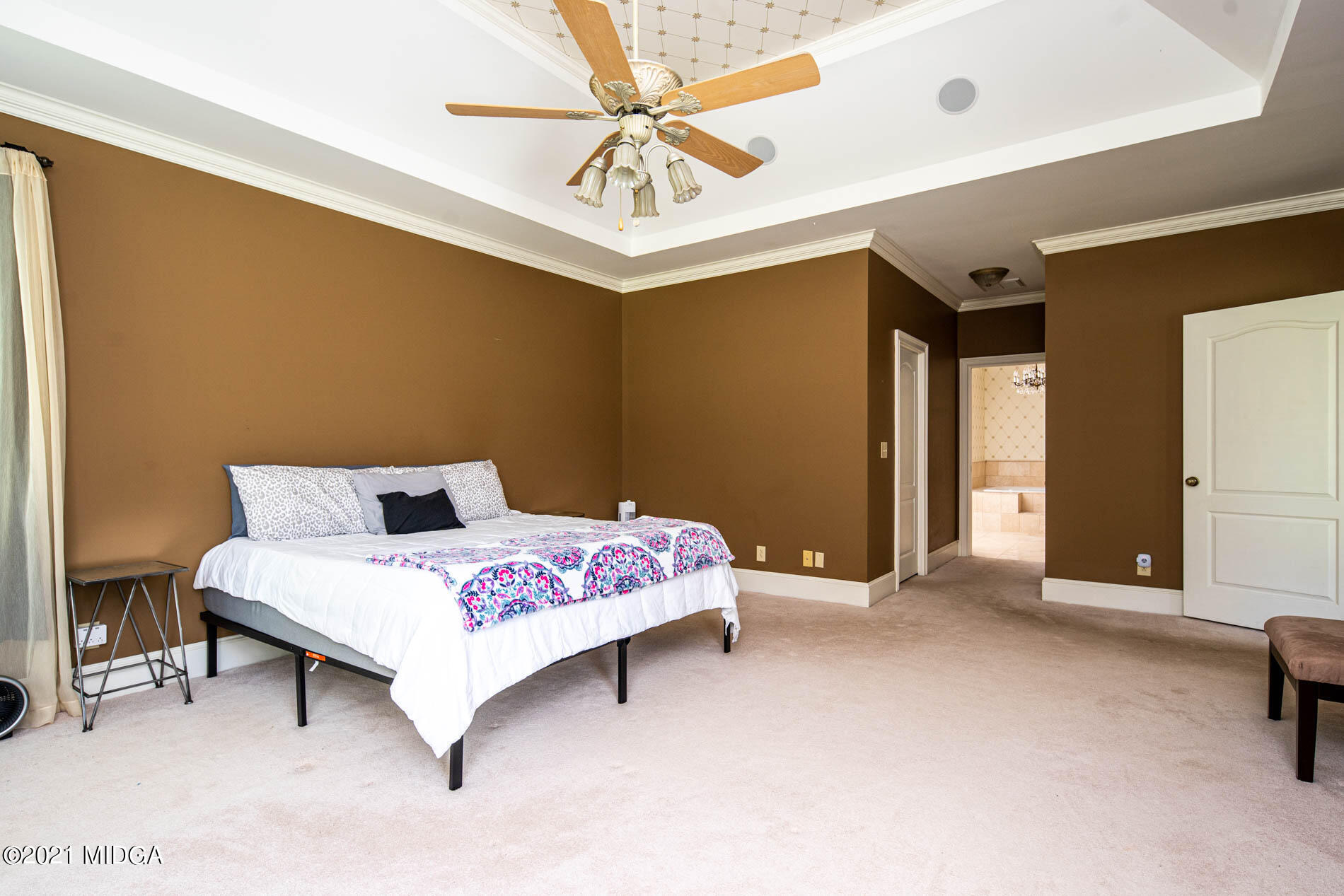 2138 Midway Road Lizella, GA 31052 - Photo 29 of 47 a bedroom with a bed and a chandelier