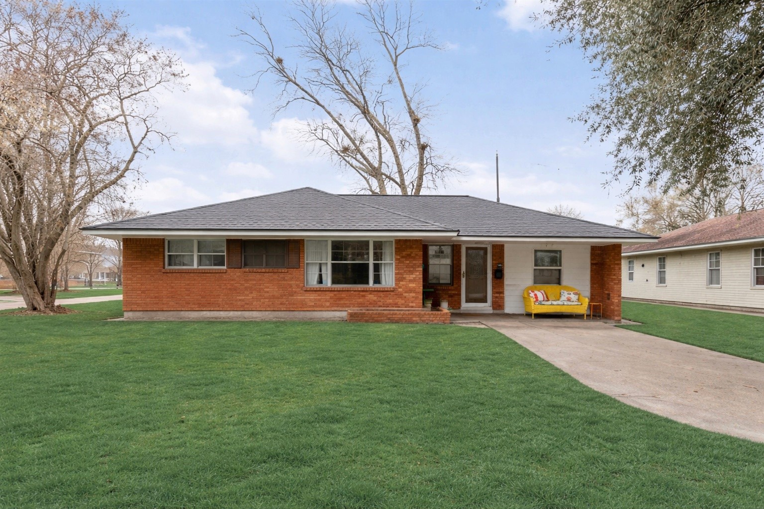 a front view of a house with a garden and porch