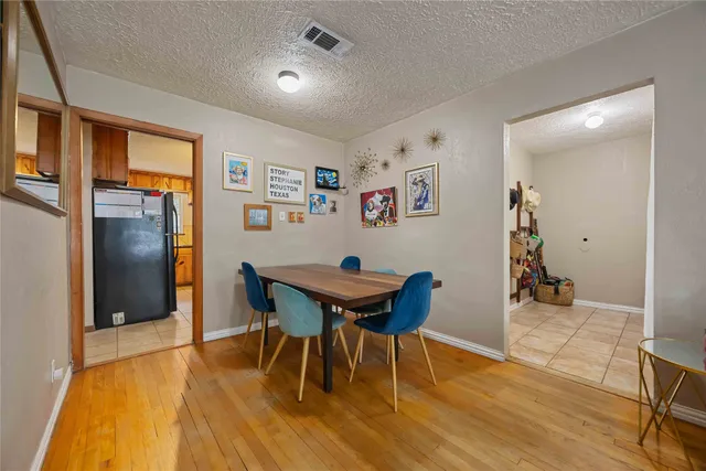 a kitchen with stainless steel appliances kitchen island granite countertop a refrigerator and a sink