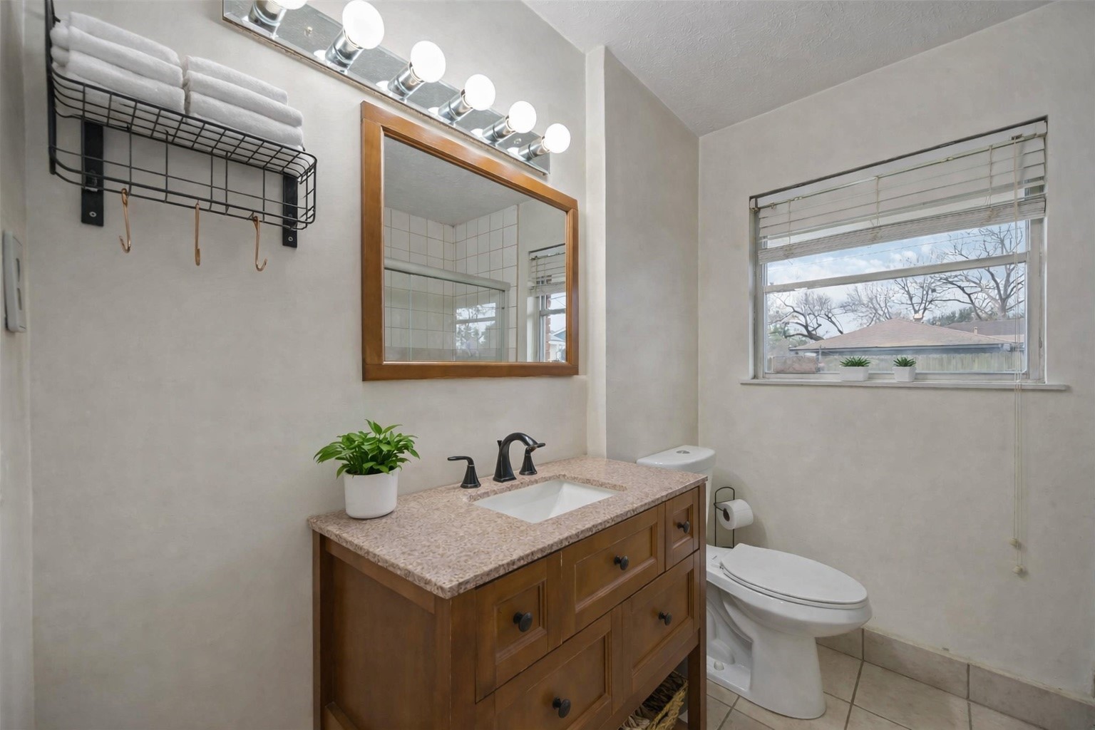 4501 Verdome Lane Houston, TX 77092 - Photo 13 of 27 a bathroom with a toilet a sink and mirror