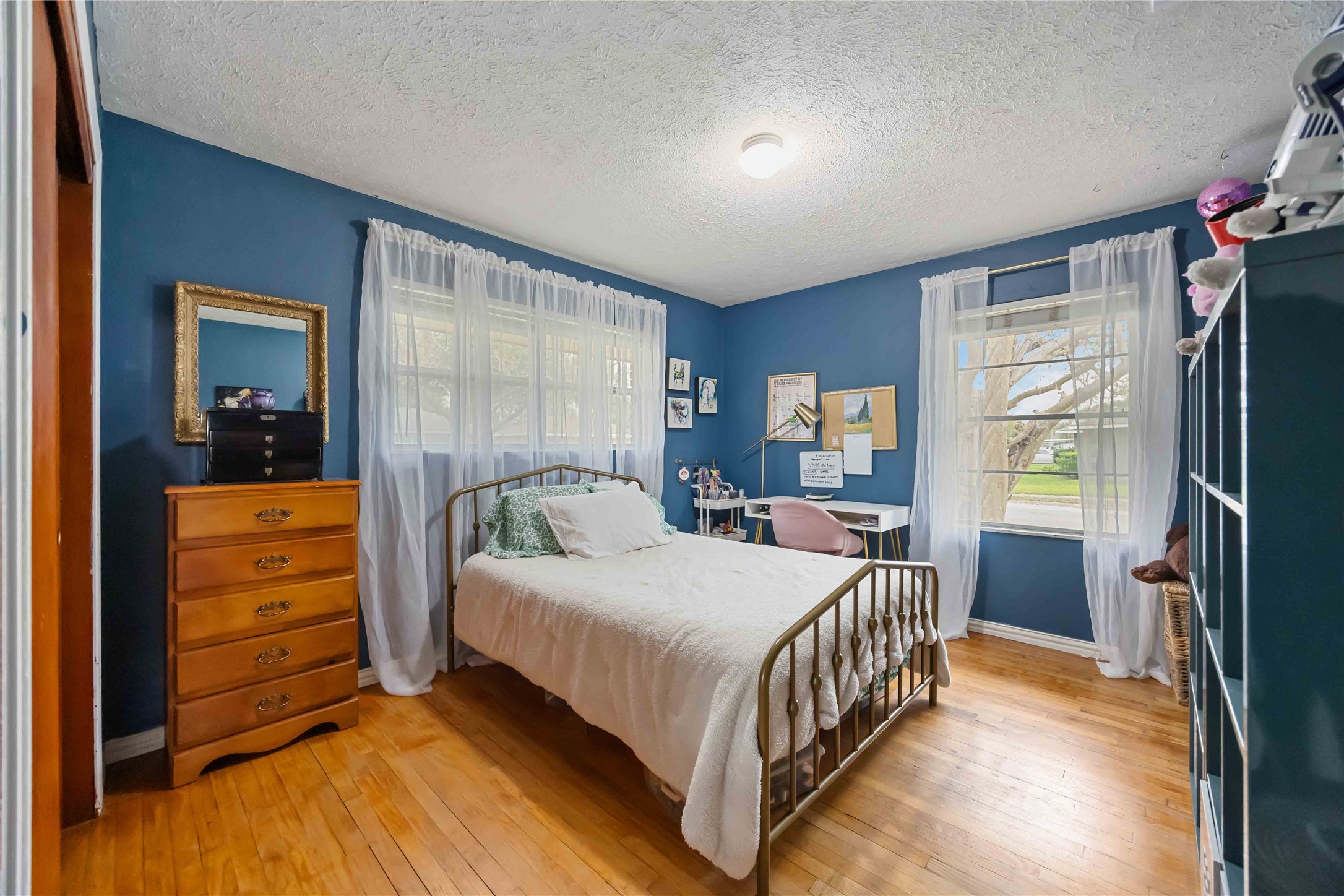 4501 Verdome Lane Houston, TX 77092 - Photo 16 of 27 a bedroom with a bed and a dresser next to a window