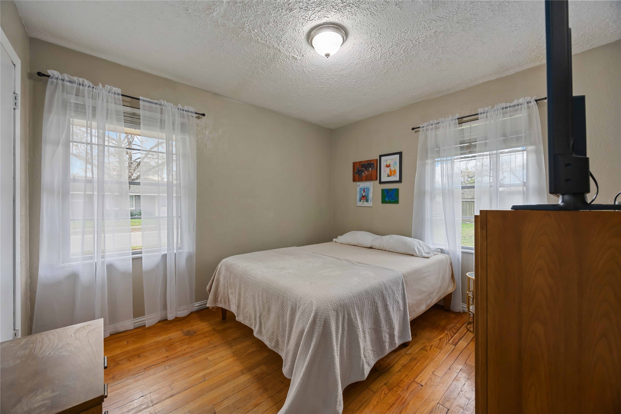 4501 Verdome Lane Houston, TX 77092 - Photo 18 of 27 a bedroom with a bed and a flat screen tv