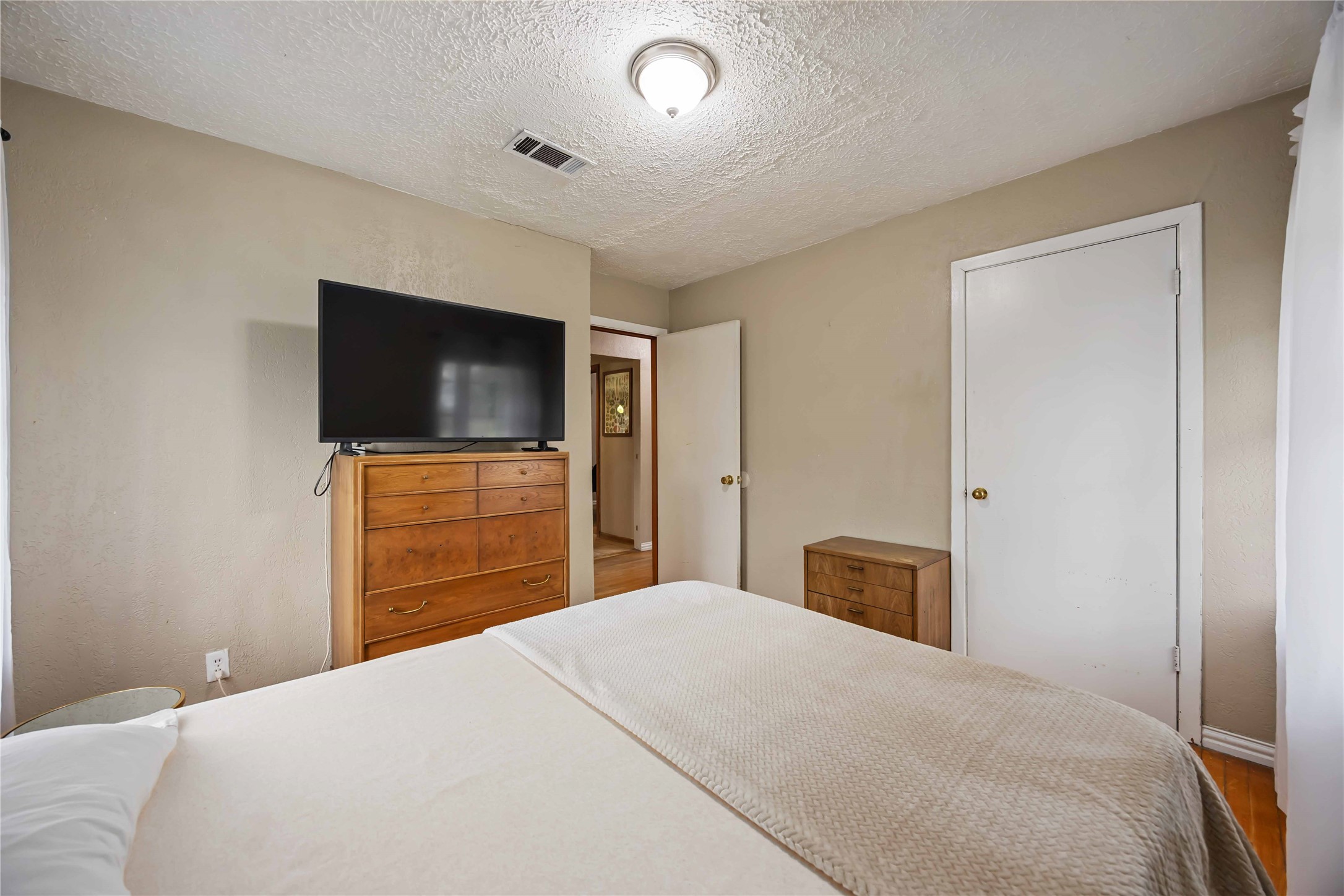 4501 Verdome Lane Houston, TX 77092 - Photo 19 of 27 a bedroom with a bed and a flat screen tv