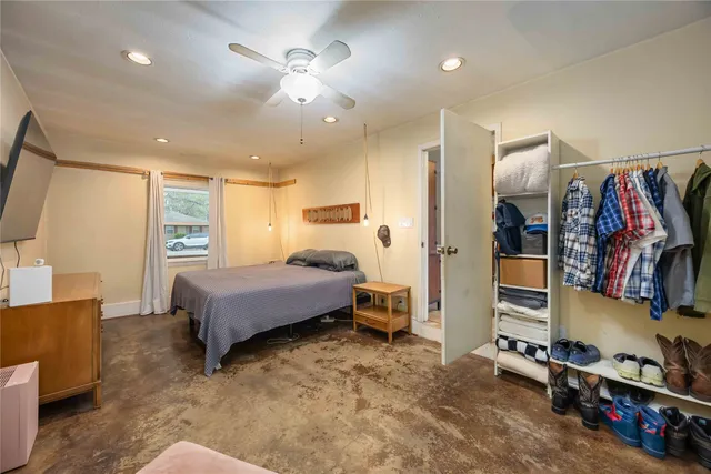 a bedroom with a bed and a flat screen tv