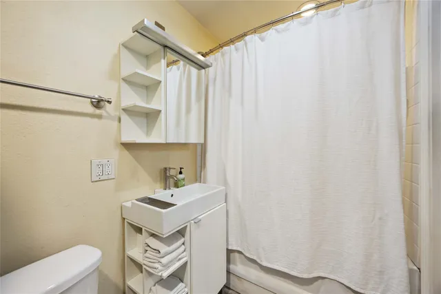 a bathroom with a sink and a washer dryer