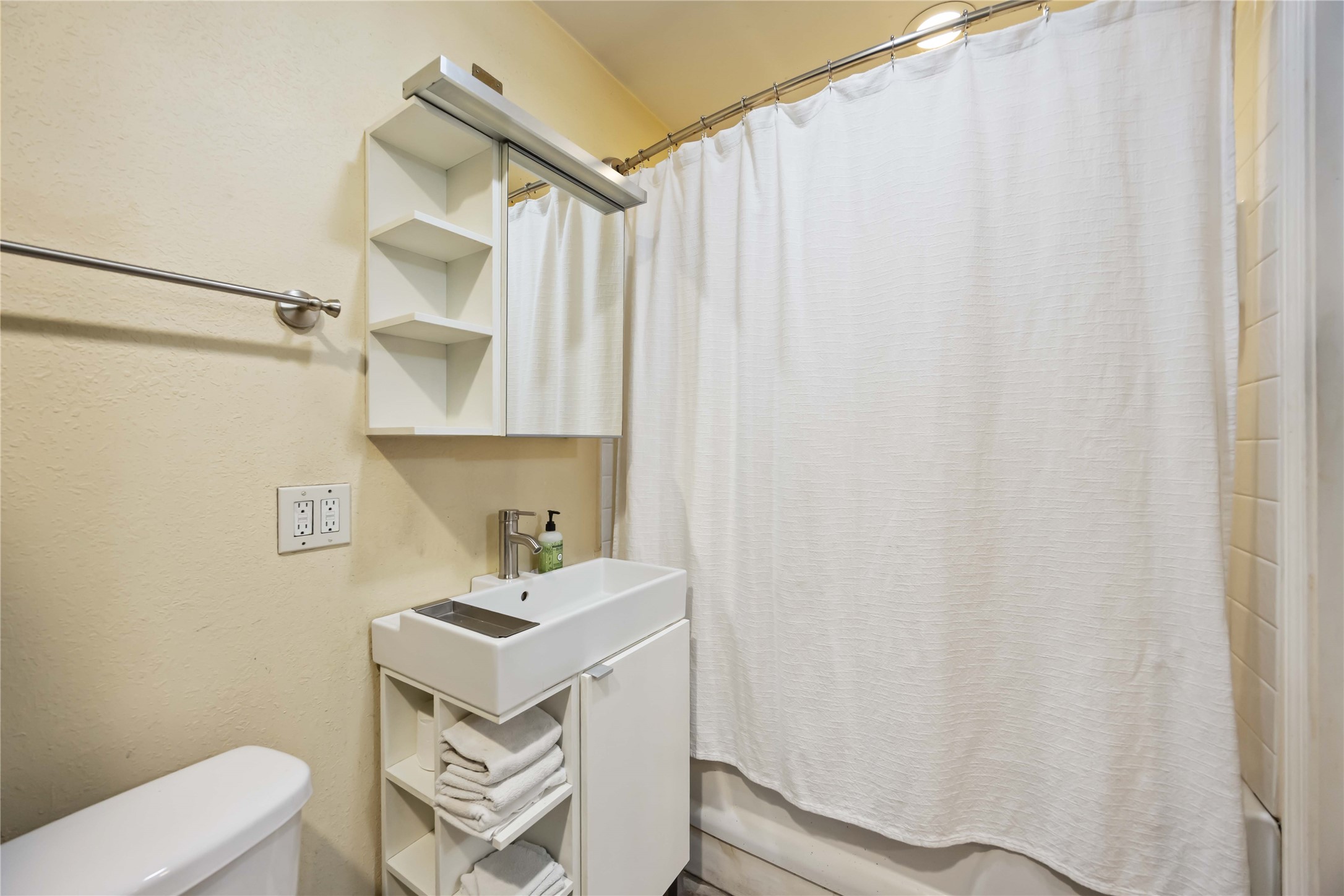 4501 Verdome Lane Houston, TX 77092 - Photo 23 of 27 a bathroom with a sink a toilet and shower curtain