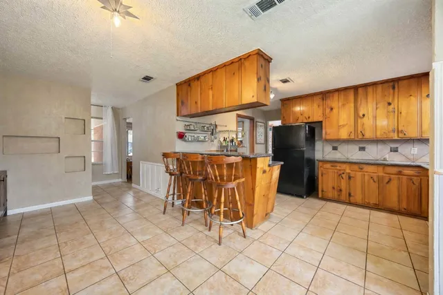 a kitchen with stainless steel appliances a refrigerator sink and cabinets