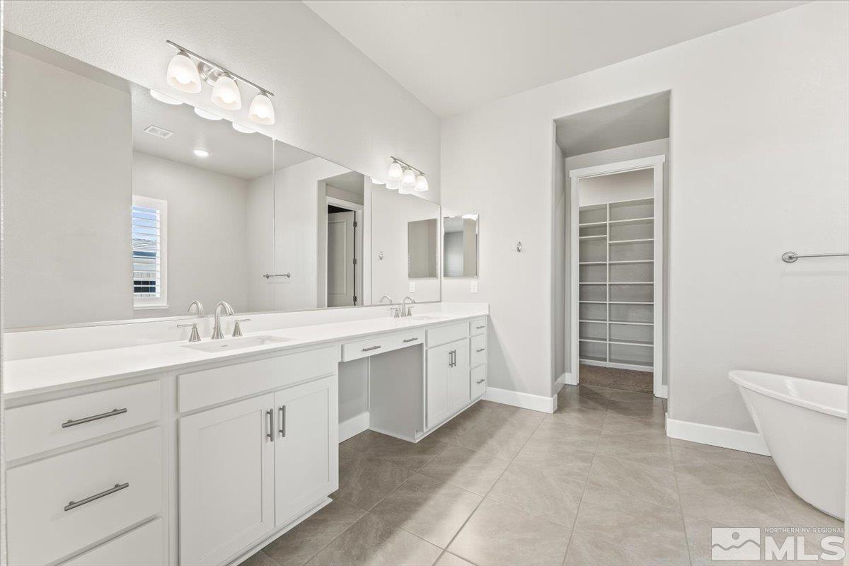 1273 Crawford Crk Drive Reno, NV 89521 - Photo 16 of 39 a spacious bathroom with a double vanity sink a large mirror and a bathtub