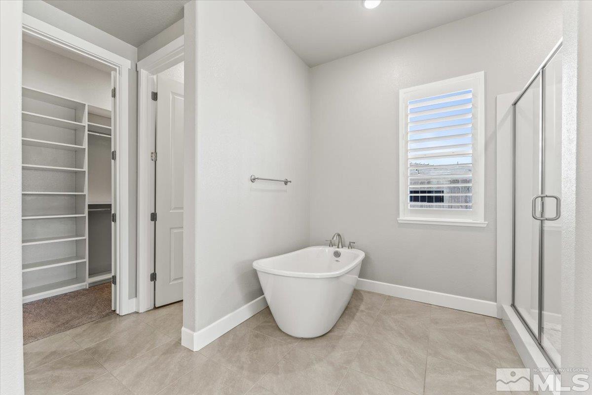 1273 Crawford Crk Drive Reno, NV 89521 - Photo 17 of 39 a bathroom with a blue toilet next to a window