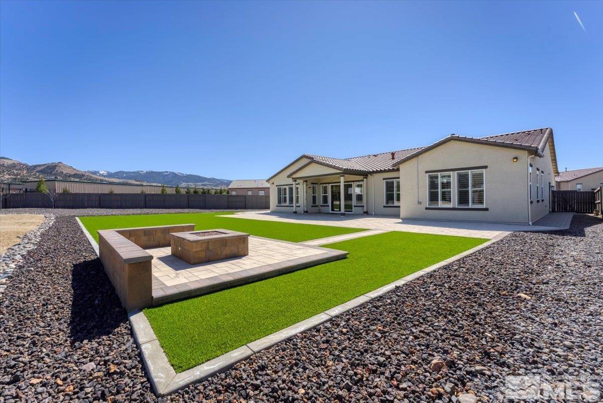 1273 Crawford Crk Drive Reno, NV 89521 - Photo 29 of 39 a view of a big house with a big yard and palm trees
