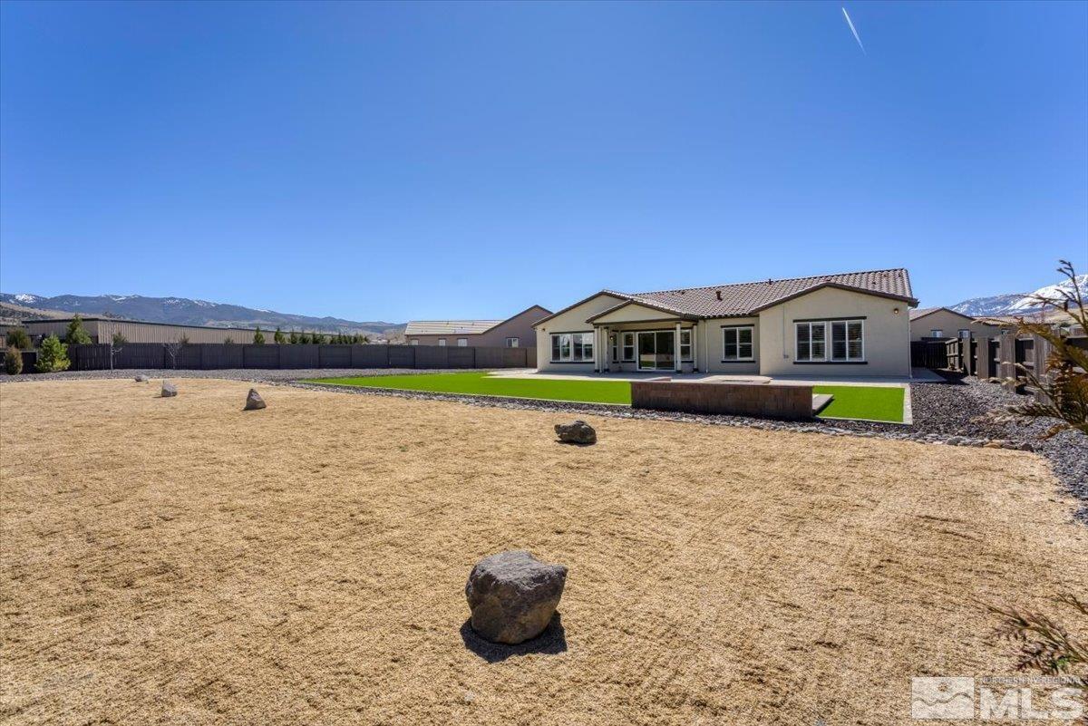 1273 Crawford Crk Drive Reno, NV 89521 - Photo 31 of 39 a front view of a house with a garden and lake view