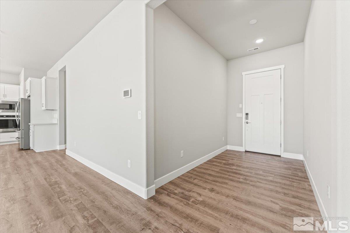 1273 Crawford Crk Drive Reno, NV 89521 - Photo 7 of 39 a view of an empty room with wooden floor