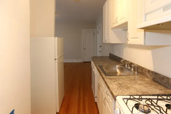 a kitchen with a sink and a refrigerator