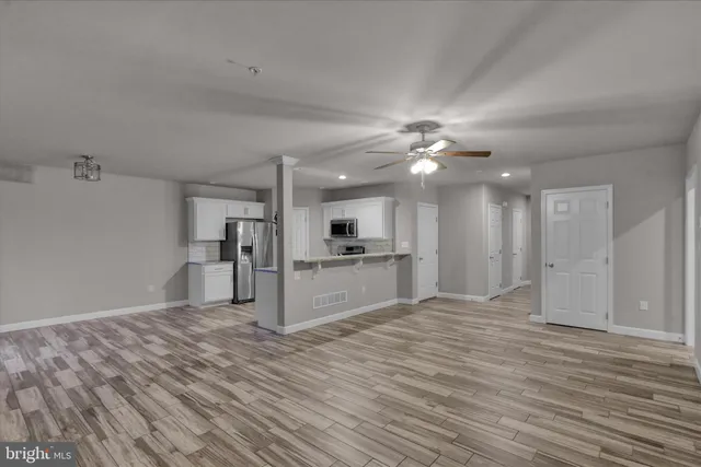 a view of a kitchen with a sink and a refrigerator