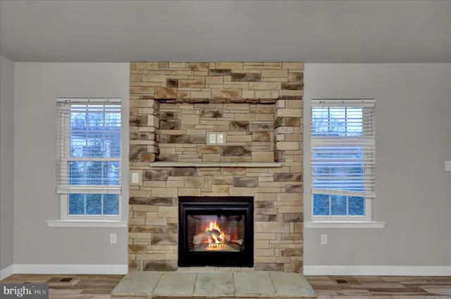 a living room with a fireplace and a window