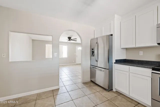 a view of a livingroom with a ceiling fan and window