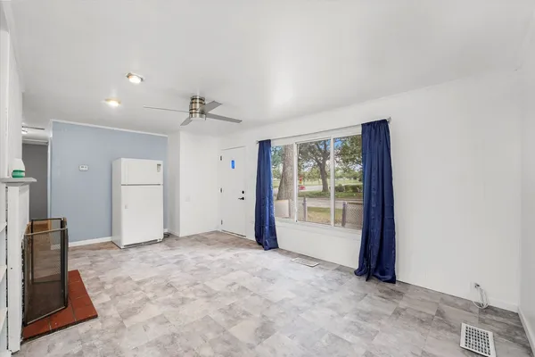 a view of empty room with a fireplace