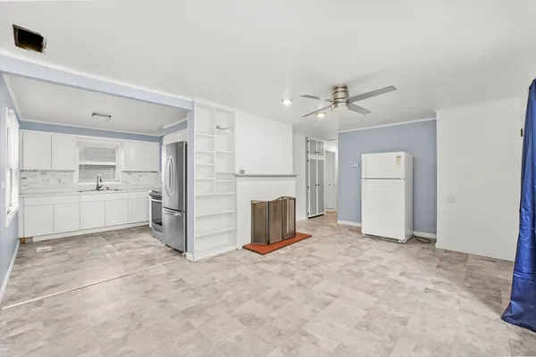 a view of a kitchen with a sink and a refrigerator