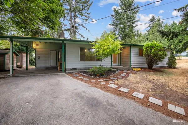 front view of a house with a tree