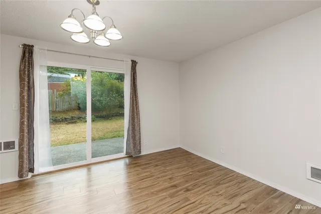 a view of a room with wooden floor and a large window