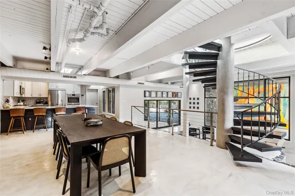 a view of a dining room with furniture and chandelier