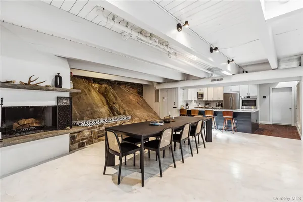a kitchen with kitchen island a sink refrigerator and cabinets