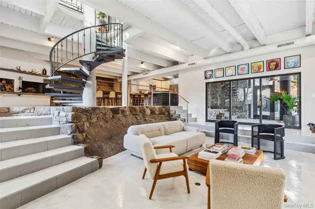 a living room with furniture ceiling fan and a rug